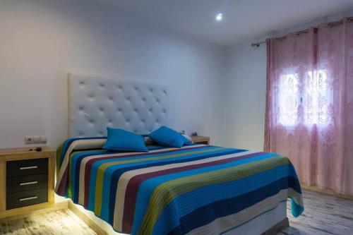 a bedroom with a large bed with blue pillows at Forest Farm in Amman