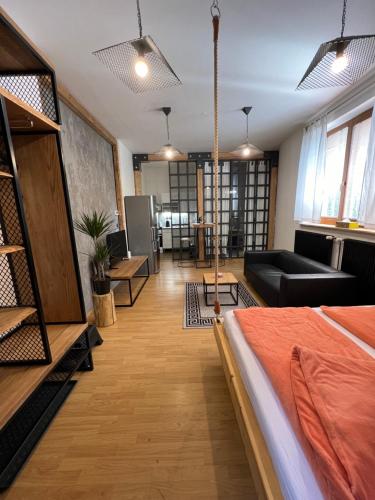 a bedroom with a bed and a living room at Apartmán Veronika Blansko in Blansko