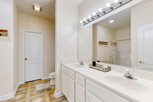 a bathroom with two sinks and a mirror at Summerlyn Condo --- 34363 Summerlyn Dr 204 in Lewes