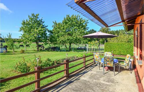 a patio with a table and chairs and an umbrella at Lovely Home In Schorfheide With Wifi in Schorfheide