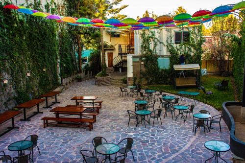 an outdoor patio with tables and chairs and umbrellas at Hotel Terra by Refugio Ecológico in Arequipa