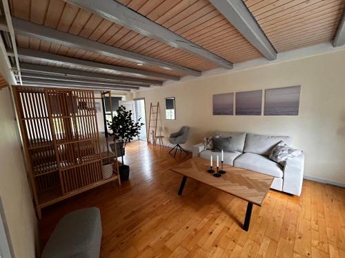 a living room with a couch and a table at Strandidyl Bed and Breakfast in Haderslev