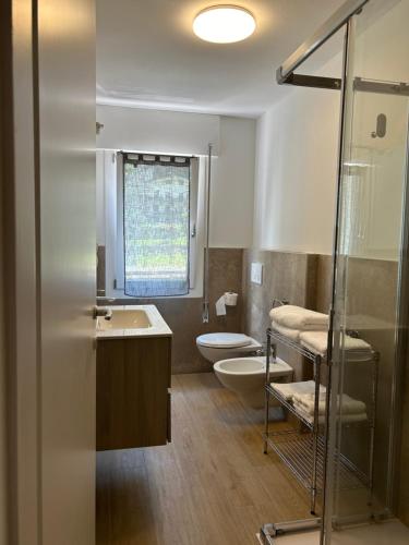 a bathroom with a toilet and a sink at Larocca Tourist Home 3 Valbrenta in Carpane