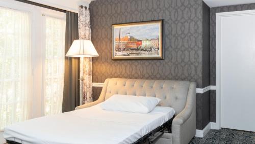 a bedroom with a bed and a picture on the wall at Historic Inns of Annapolis in Annapolis