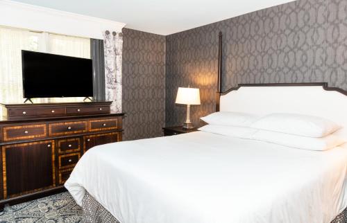 a bedroom with a bed and a flat screen tv at Historic Inns of Annapolis in Annapolis