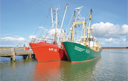 two boats are docked next to a dock at Holiday Home Rømø 57 in Bolilmark