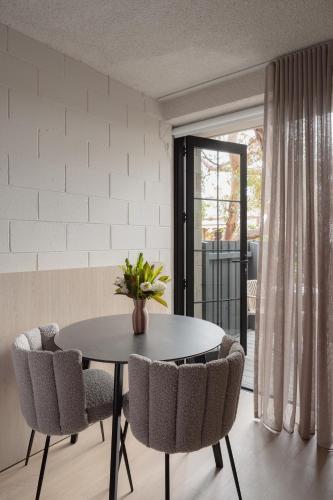 a dining room with a table and chairs at MAC Richmond by Melbourne Apartment Collection in Melbourne