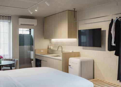 a kitchen with a white refrigerator and a sink at MAC Richmond by Melbourne Apartment Collection in Melbourne
