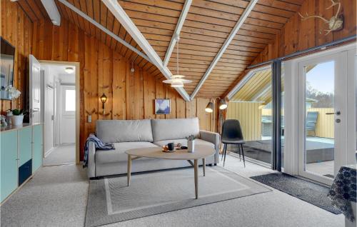 a living room with a couch and a table at Holiday Home Fjordparken Hadsund Iii in Odde