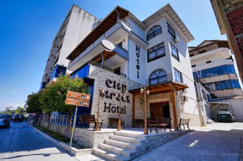 a building with a hotel on the side of a street at City Street Hotel in Gjirokastër