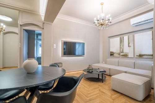 a living room with a table and a couch at Urban Elegance in Kolonaki in Athens