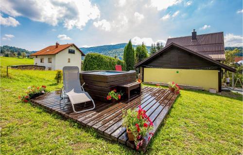 a deck with a hot tub and a grill in a yard at Cozy Home In Prezid With Wifi in Prezid