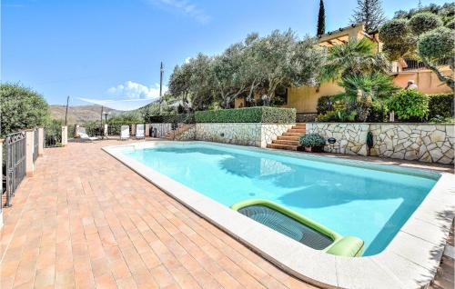 a swimming pool in a yard with a fence and a house at Mages in Casteldaccia
