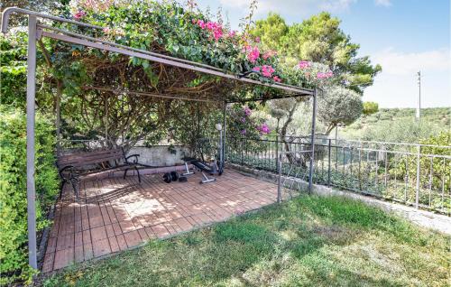 a patio with a bench and flowers on a fence at Mages in Casteldaccia