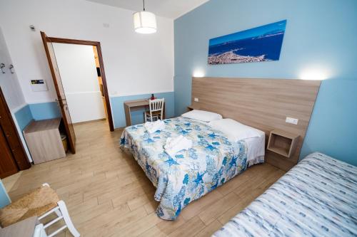 a hotel room with two beds and a mirror at B&B Profumi di Sicilia in Valderice