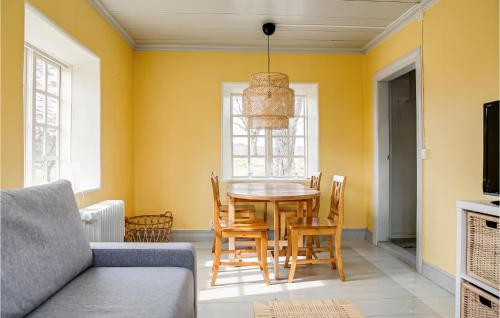 a dining room with a table and chairs at Awesome Home In Långserud With Wifi in Eldansnäs