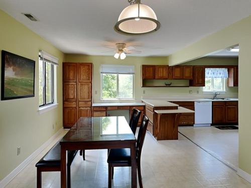 a kitchen with a table and a dining room at Just Another Day in Paradise in Surf City