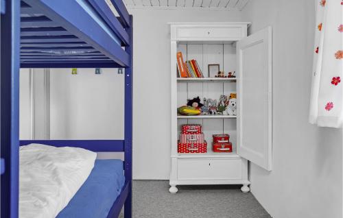 a bedroom with a blue bunk bed and a book shelf at Gorgeous Home In Ørsted With Kitchen in Ørsted