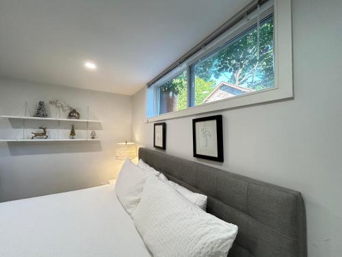 a bedroom with a bed and a large window at Modern Lux Family Rooms - KingBed - Near Sheppard W Station Toronto in Toronto