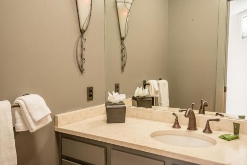a bathroom with a sink and a large mirror at Knob Hill Ridge Townhome 1 in Ketchum