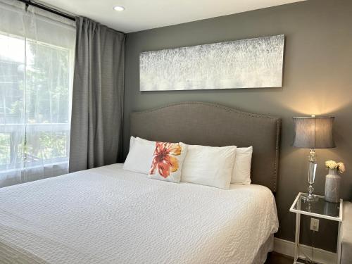 a bedroom with a bed with white pillows at Modern Lux Family Rooms - KingBed - Near Sheppard W Station Toronto in Toronto