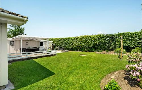 a large yard with a house and a garden at Holiday Home Haderslev With Fireplace Ii in Diernæs