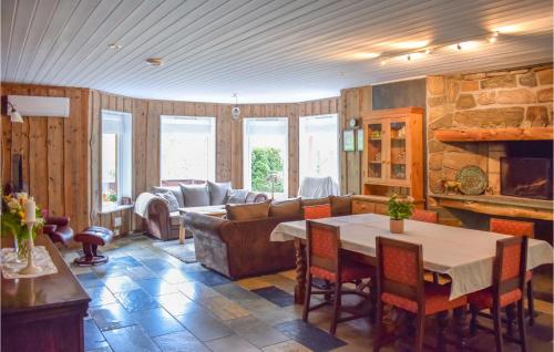 a living room with a couch and a table at Amazing Home In Matredal With Kitchen in Haugsvær