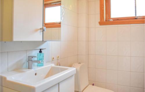 a bathroom with a sink and a toilet at Amazing Home In Matredal With Kitchen in Haugsvær