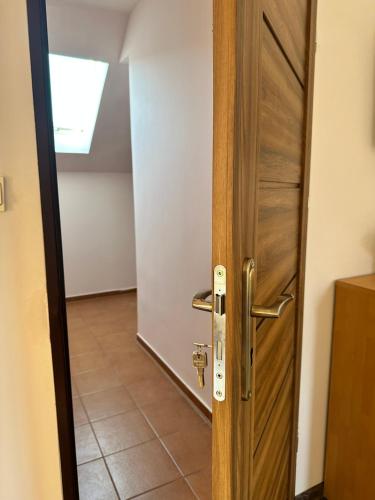 an open wooden door with a hallway behind it at Pokoje Teligi 4 pokój 3 in Świnoujście