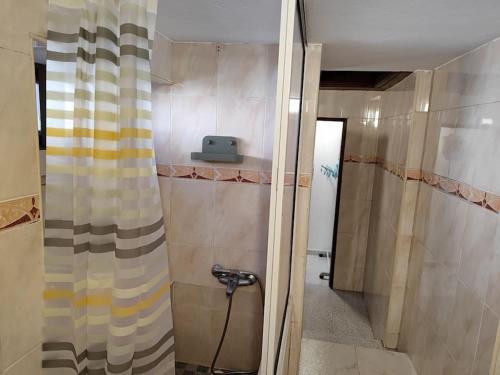 a bathroom with a shower curtain and a sink at Moradia em Alvarinhos in Alvarinhos