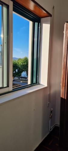 a window in a room with a view of a street at House Mariona in Caminha