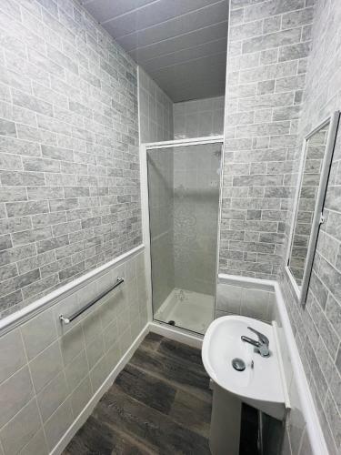 a bathroom with a shower and a toilet and a sink at Tower Central hotel Albert Road in Blackpool