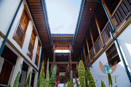 a building with a wooden ceiling with windows and plants at Hotel San Miguel de Salento in Salento