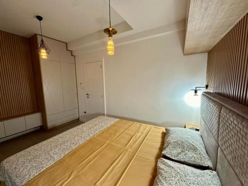 a bedroom with a bed with a wooden head board at Adriatic Dream in Tivat