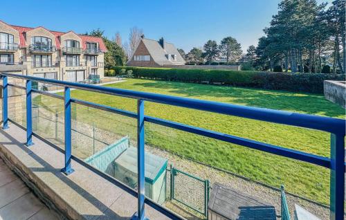 a blue bench sitting on a railing in a yard at Awesome Apartment In Bredene With Wifi in Bredene
