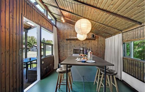 a small kitchen in a house with a table and stools at Amazing Home In Hampen With Wifi in Hampen