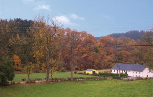 a house in the middle of a field with trees at Astrid in Burg-Reuland