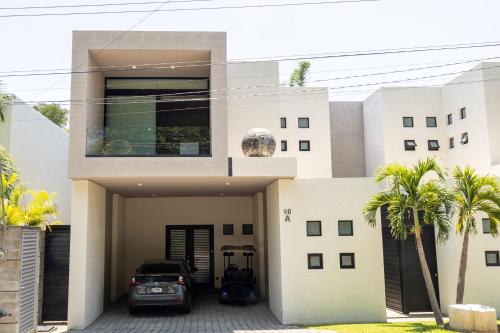 a house with a car parked in front of it at New Santa Fe Home Private Relaxation Realm in Xochitepec