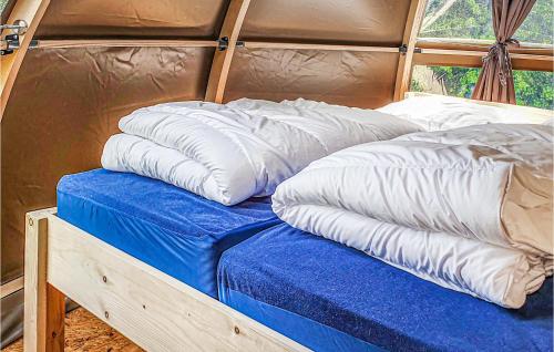 a couple of pillows sitting on top of a bed at Amazing Stacaravan In Hoogersmilde in Hoogersmilde