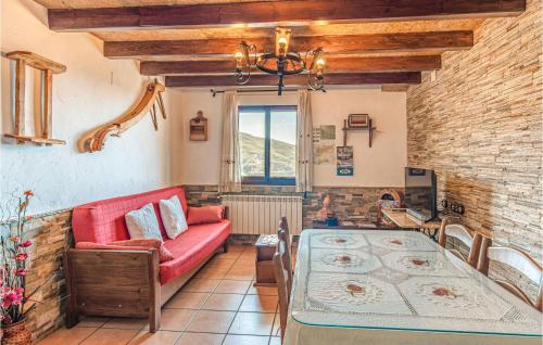 a living room with a red couch and a table at Pet Friendly Home In Mecina Bombarón in Mecina Bombarón