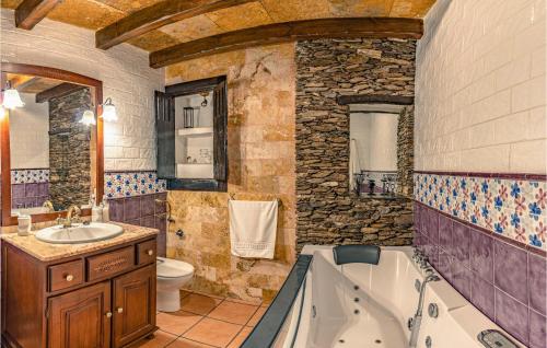 a bathroom with a tub and a toilet and a sink at Pet Friendly Home In Mecina Bombarón in Mecina Bombarón