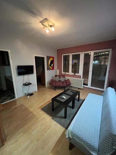 a living room with a couch and a table at Square Vanilla Apartments in Skopje