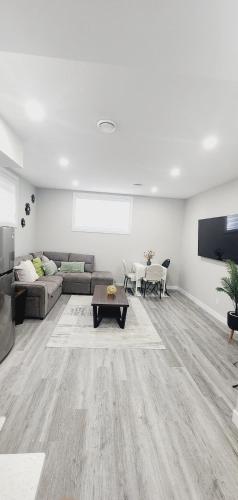 a living room with a couch and a table at fabulous and cozy guest suite in Calgary