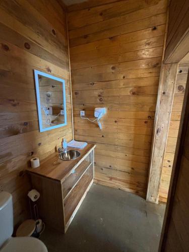 a bathroom with a sink in a wooden wall at COMPORTA SIDE - Lake in Setúbal
