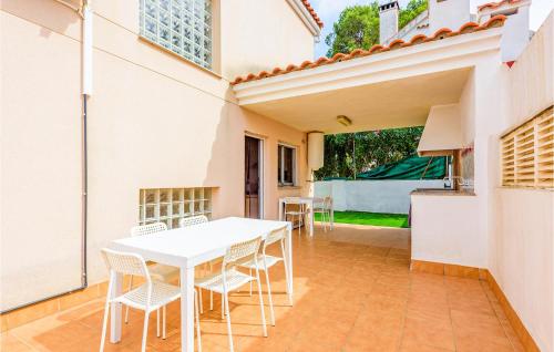 a white table and chairs on a patio at Beautiful Home In Oropesa Del Mar in Oropesa del Mar