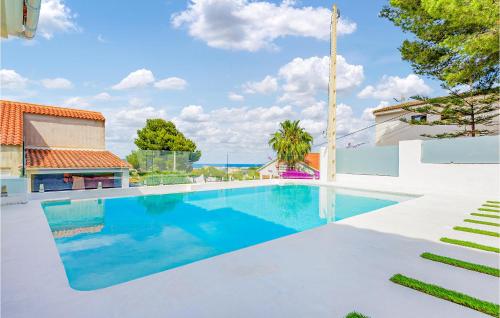 a swimming pool with a view of the ocean at Beautiful Home In Oropesa Del Mar in Oropesa del Mar