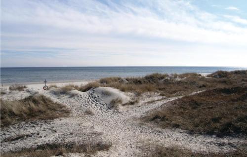 a dirt path to the beach with the ocean in the background at 1 Bedroom Beautiful Home In Borrby in Borrby
