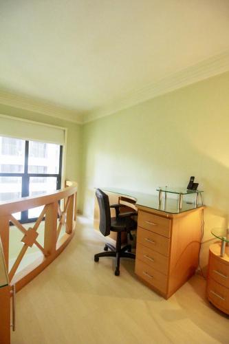 an office with a desk and a chair and a window at Apartamento Duplex Place Vendome! Moema, 58m2, Amplo, Conforto, Luxo! Servicos, Estacionamento, Internet, Metro! in Sao Paulo