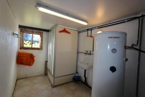 a bathroom with a toilet and a sink at Plans in La Lécherette