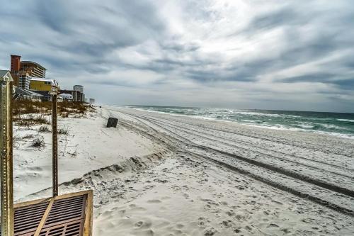 a beach with footprints in the sand and the ocean at Paradise Cove in Panama City Beach